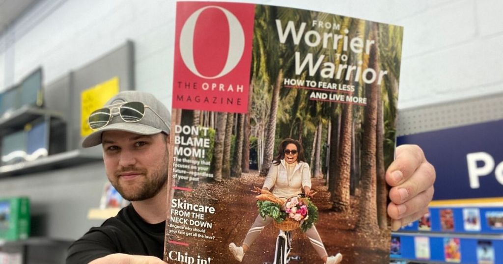 Man holding up a copy of O magazine
