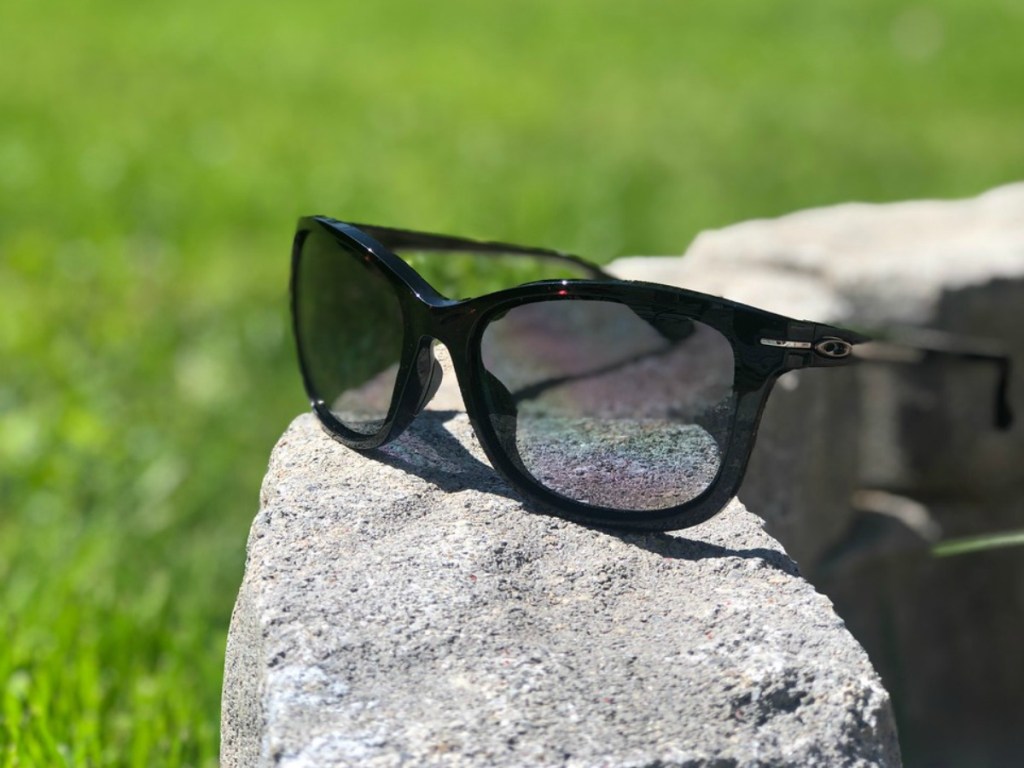 black Oakley sunglasses on concrete outside