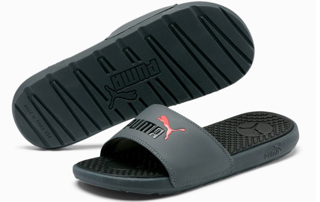 black pair of slide sandals with pink puma cat logo on top