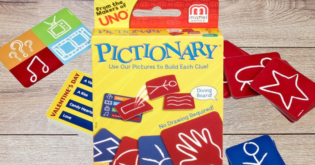 yellow box for pictionary card game with cards behind it on wooden table 