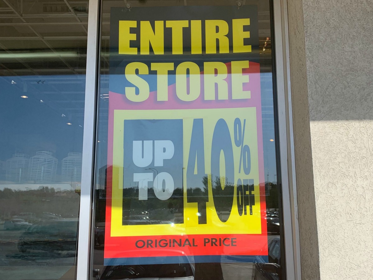 Store front window with sale sign