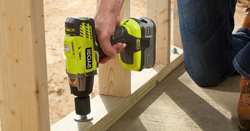 man using RYOBI wrench on wood beam