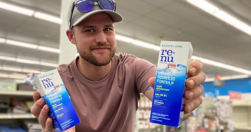 man holding two boxes of contact solution