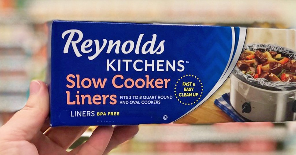 person holding blue box of reynolds slow cooker liners