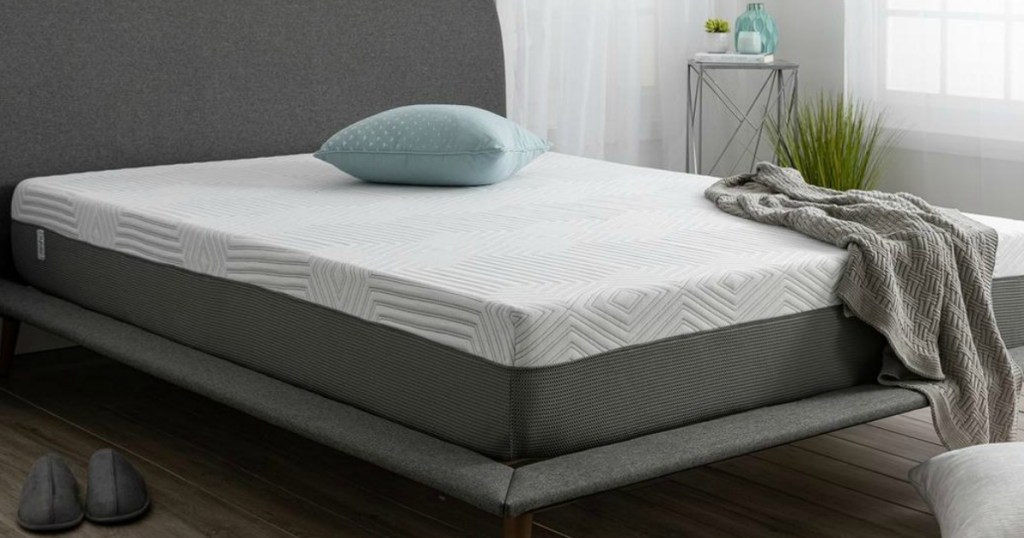 Sealy Mattress shown with pillow and throw