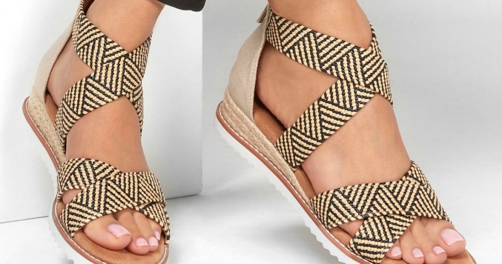 Woman wearing crosshatch patterned Skechers Desert Sandals