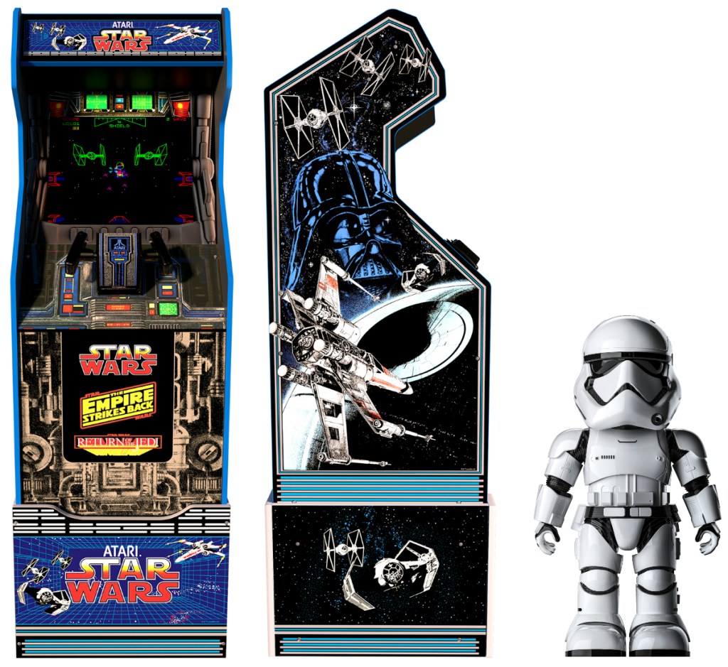 Front and side view of a Star Wars themed arcade game near a robot 