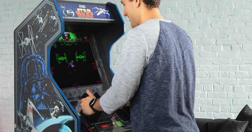 Man playing a Star Wars themed arcade game