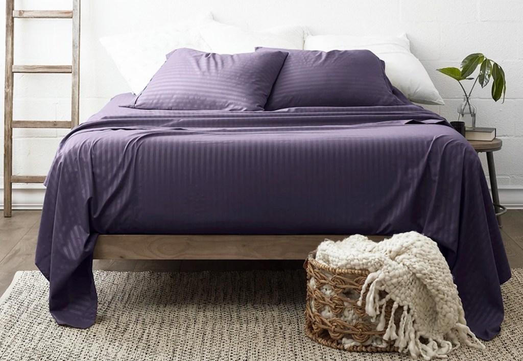 dark purple stripped embossed sheet set on bed