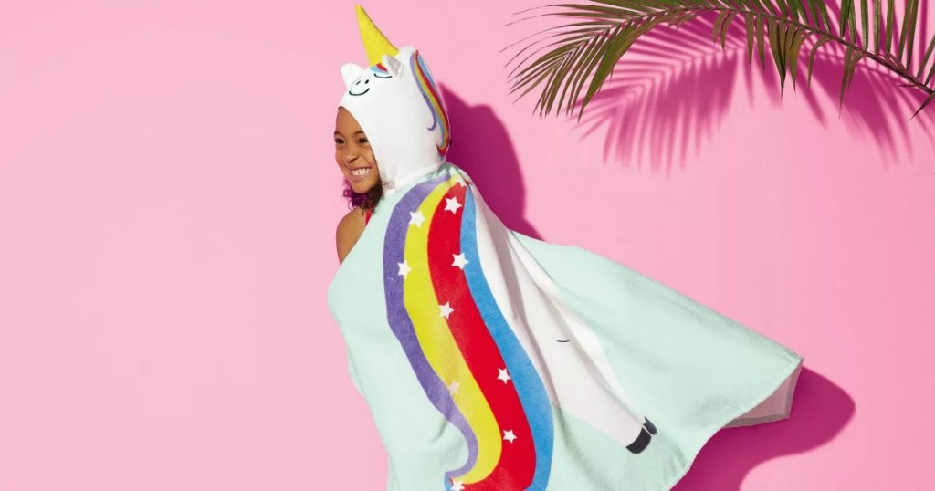 girl wearing unicorn hooded beach towel