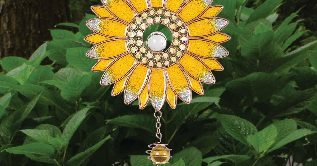 sunflower wind chime with foliage in background