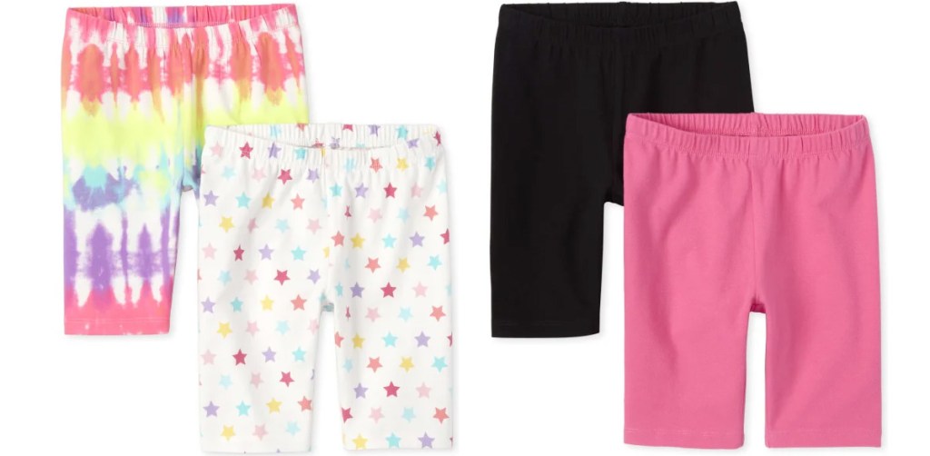 two 2-packs of girls bike shorts in tie dye, white with stars, black, and pink colors