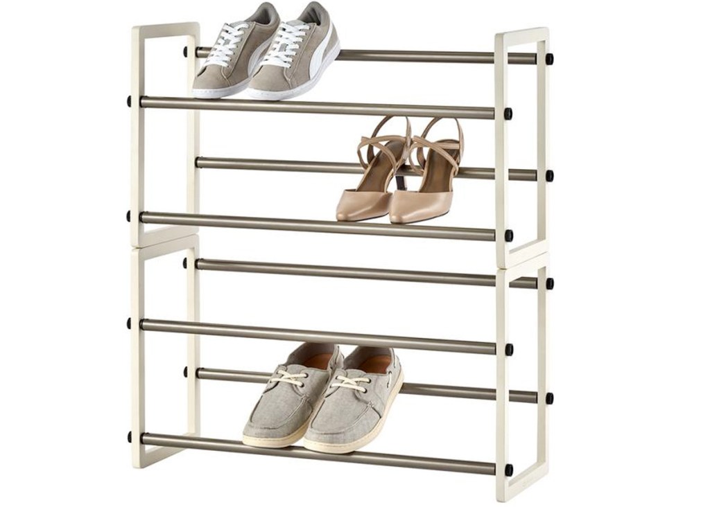 white shoe rack with four levels and three pairs of shoes on it