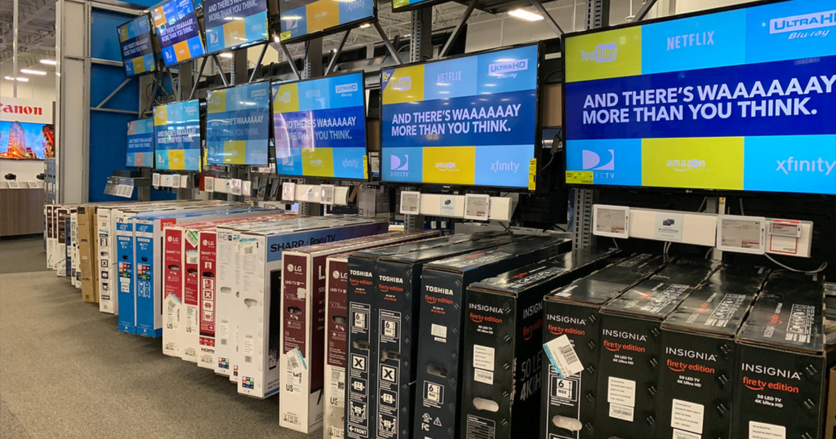 best buy black friday tvs lined up on the wall and in boxes