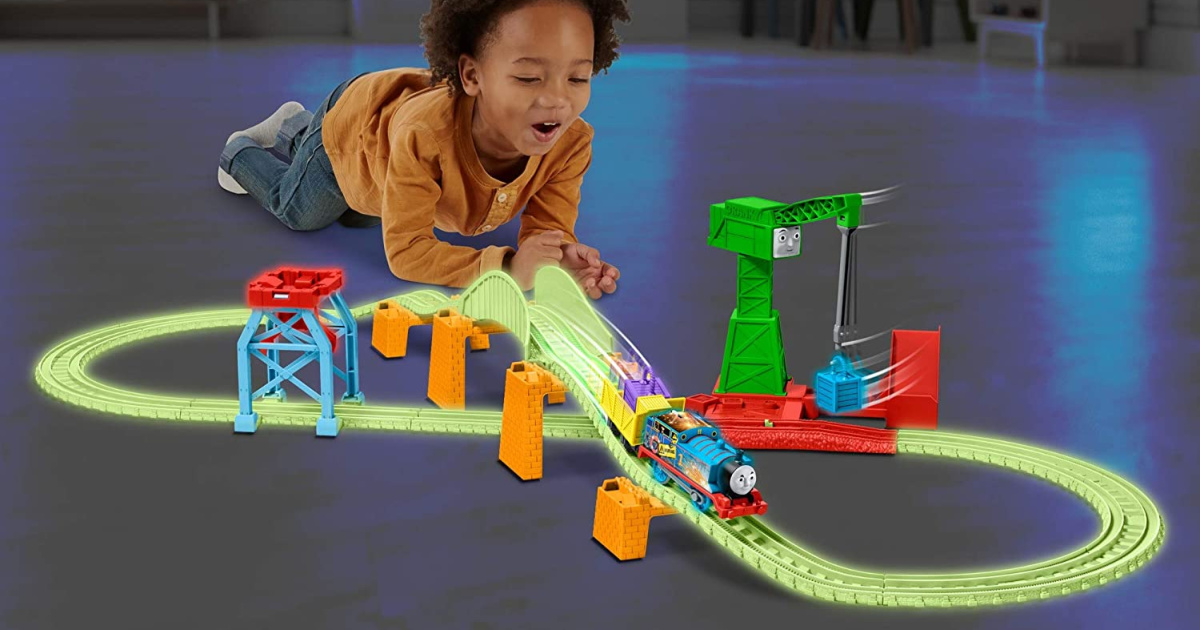 kid playing with Thomas the Train glow in the dark set