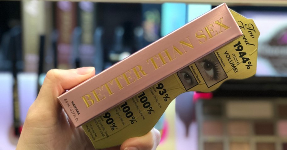 hand holding mascara in box in makeup store