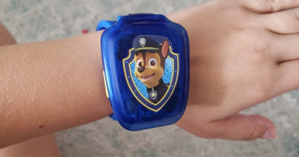 childs arm wearing blue chase paw patrol watch