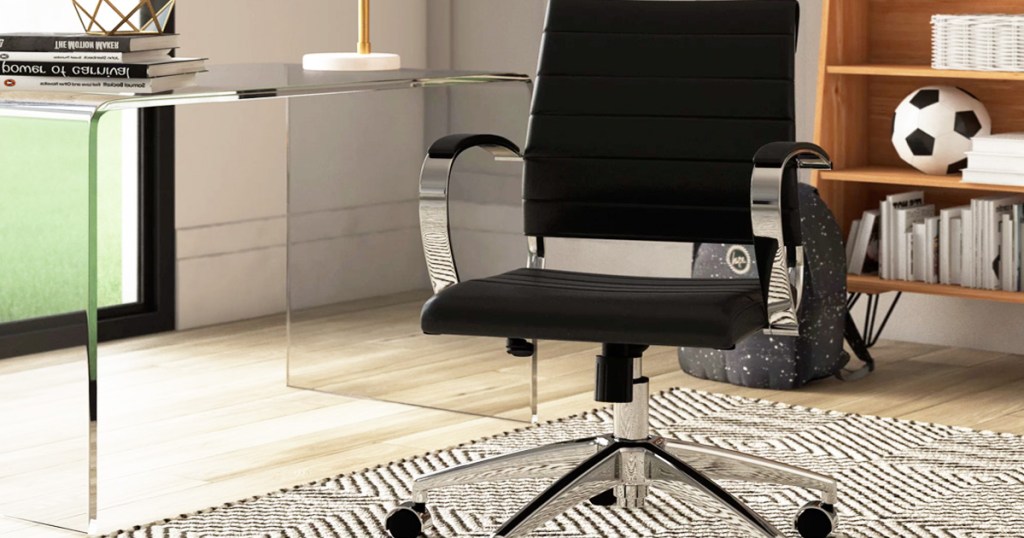 black leather office chair with silver arms and legs in a home office