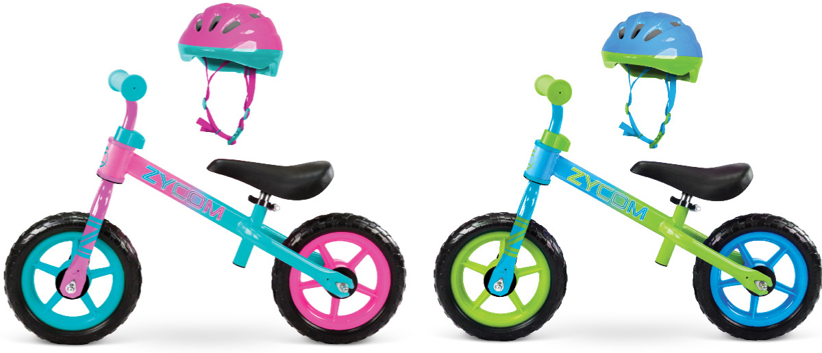 2 zycom toddler balance bikes next to each other with helmets