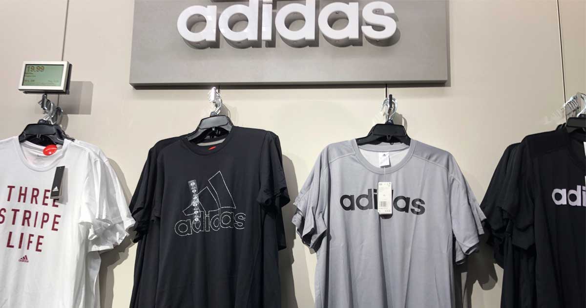 adidas shirts hanging on a display in a store
