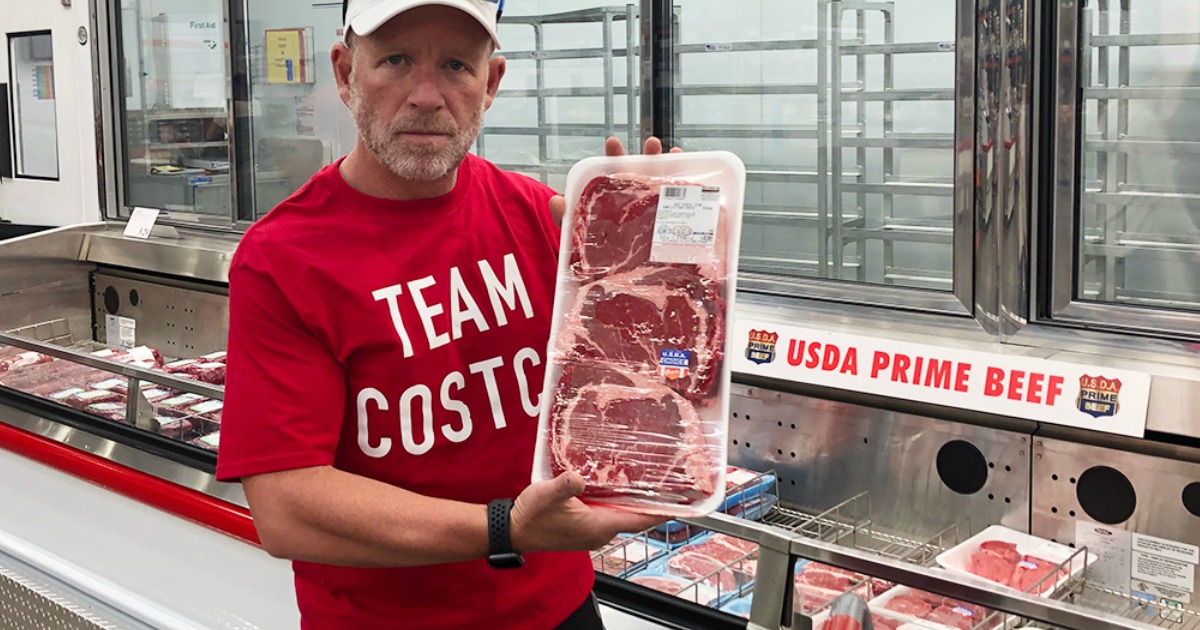 man holding package of meat at costco