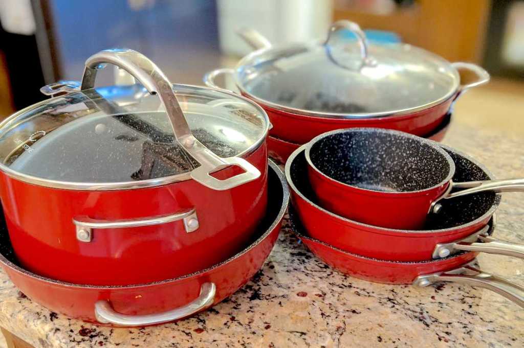 stacks of red pots and pans on kitchen counter