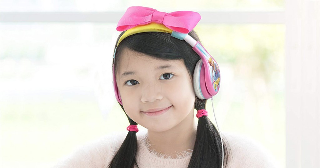 girl wearing pink, white, and yellow colored headphones with pink bow on top