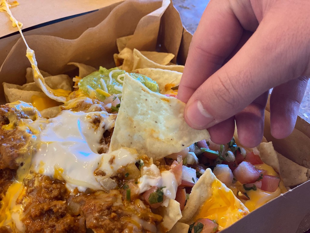 dunking chip in Taco Bell nachos 