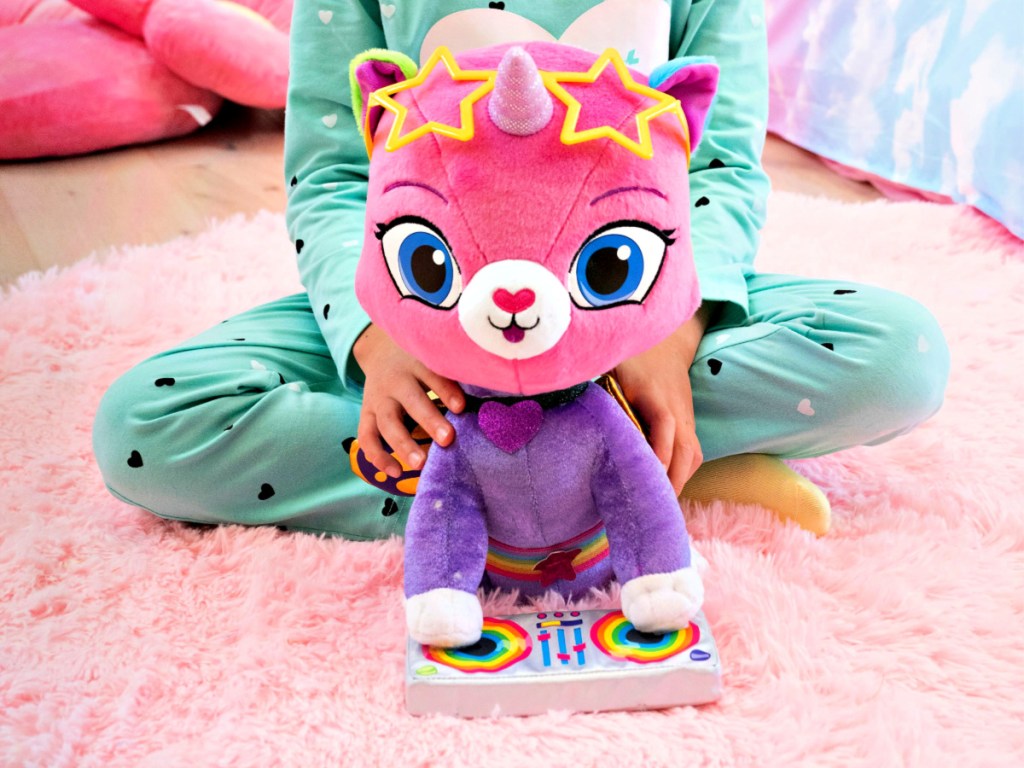 girl holding Rainbow Butterfly Unicorn Kitty DJ Felicity Plush