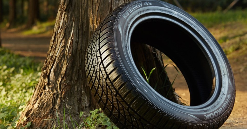 hankook kinergy tire leaning on tree