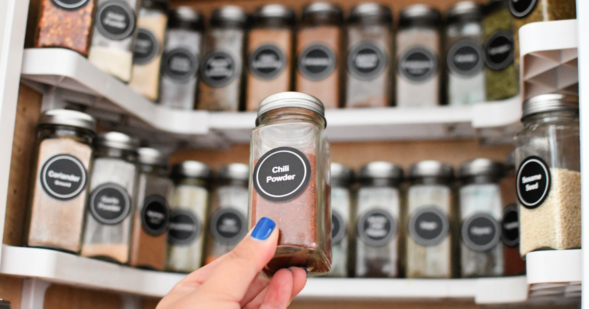 holding a jar of spices after organizing cabinet