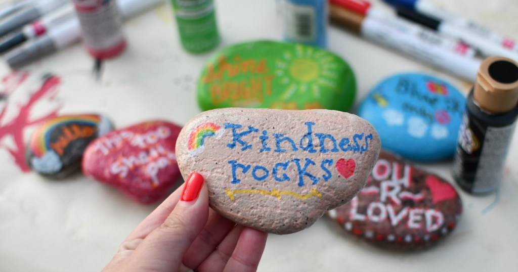 holding a painted kindness rock