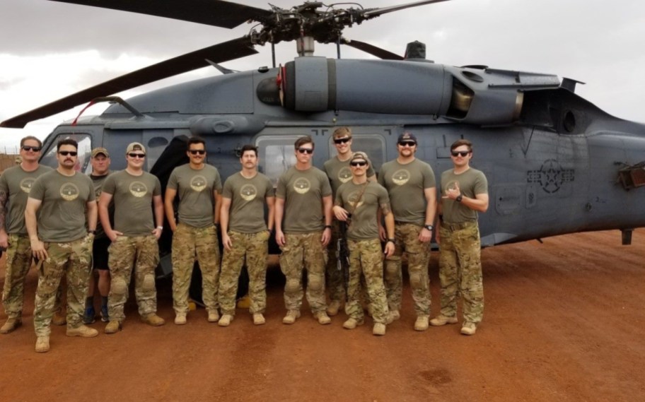 military members next to helicopter