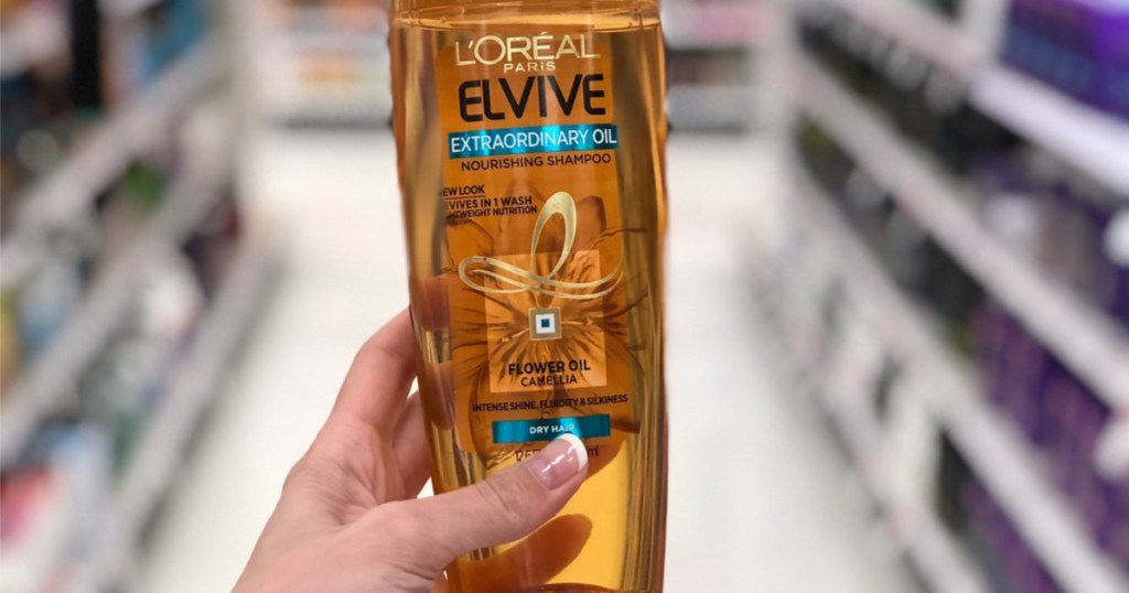 hand holding loreal elvive shampoo in store
