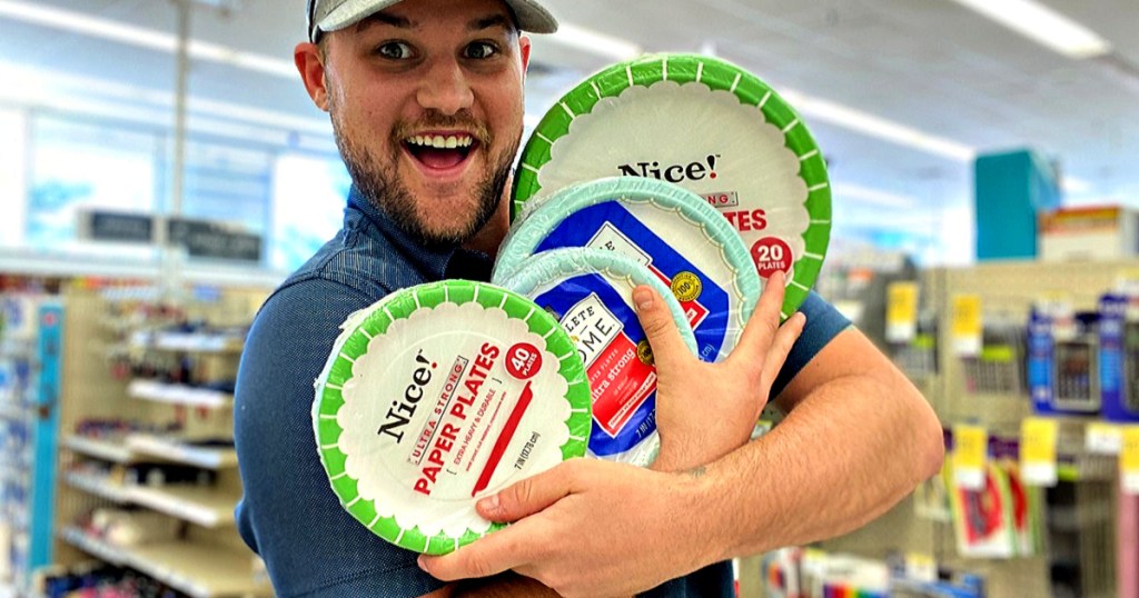 man in hat holding paper plates at store