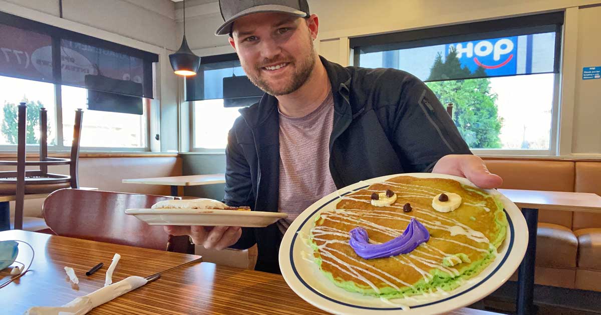 man holding a plate with a mummy pancake