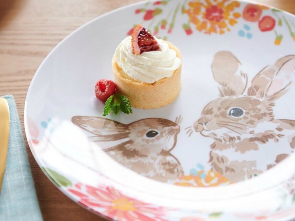 plate with bunny graphics and a frosted cupcake on it