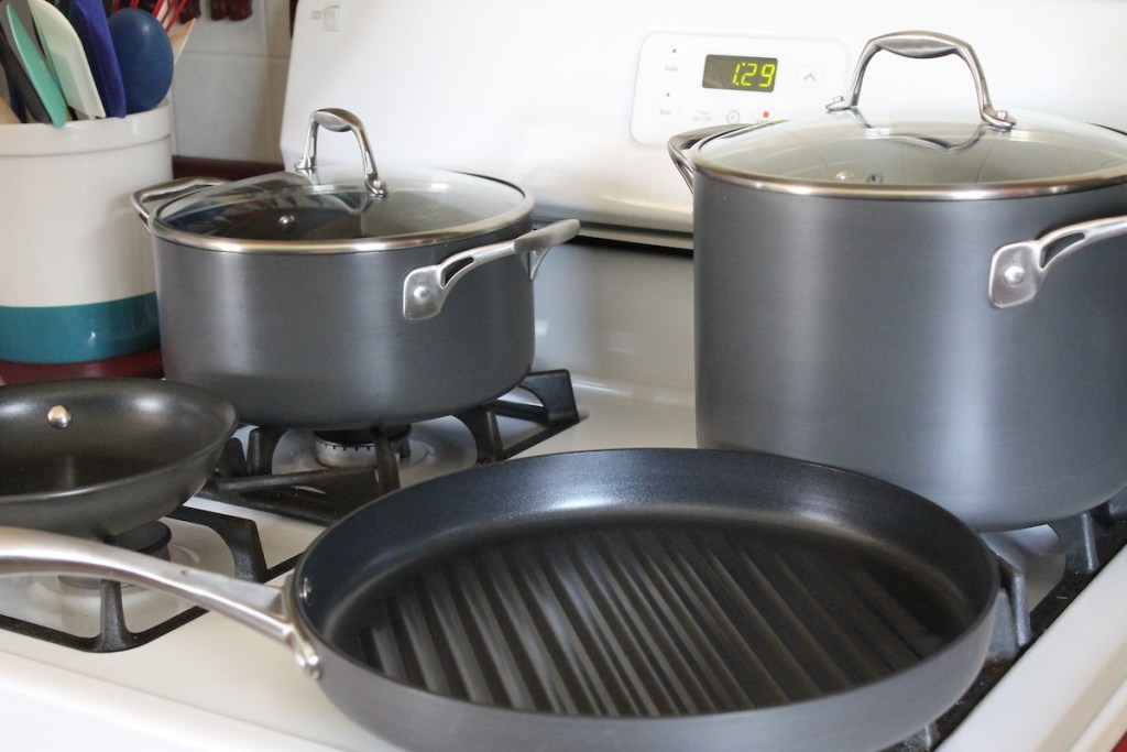 gray pots and pans on top of white stove 