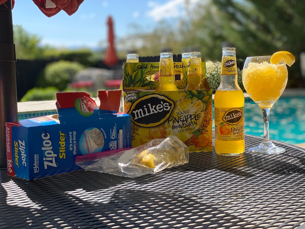 Mike's Hard Pineapple Lemonade on outdoor table with wine glass