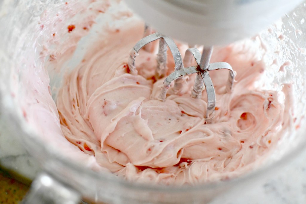 mixing stawberry cream cheese frosting