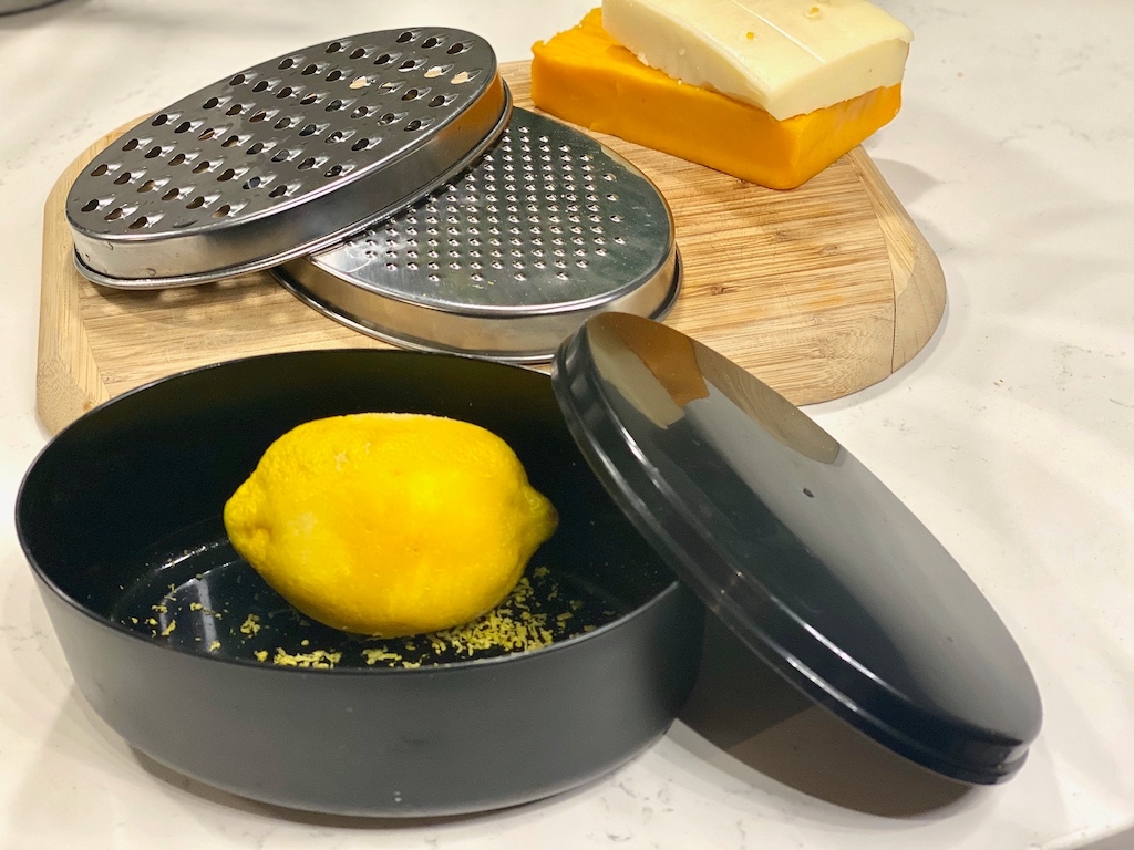 multi-use cheese grater with lemon and cheese blocks 