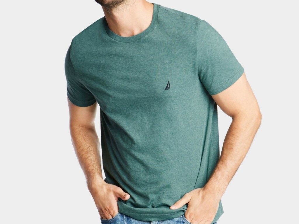 man wearing green shirt with hands in his pockets