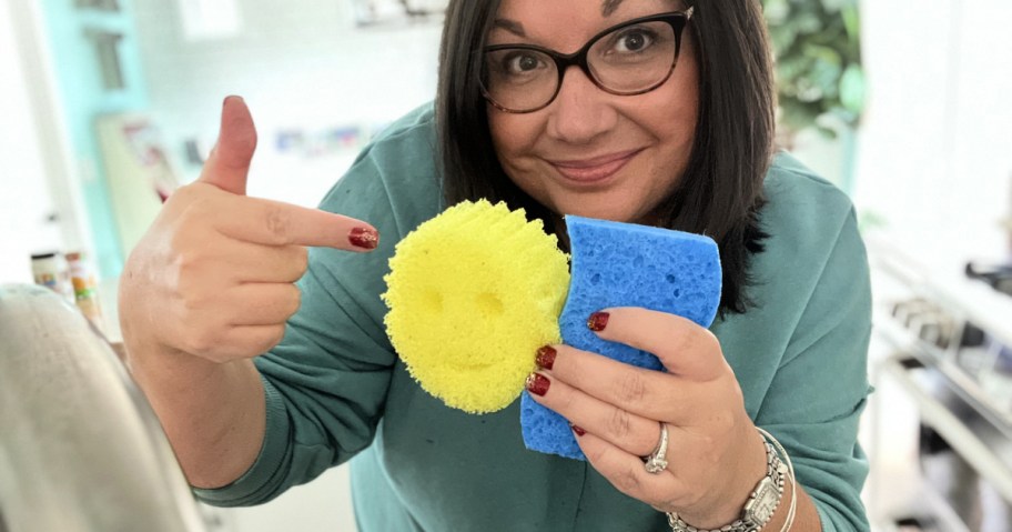 woman holding up sponges and pointing to scrub daddy