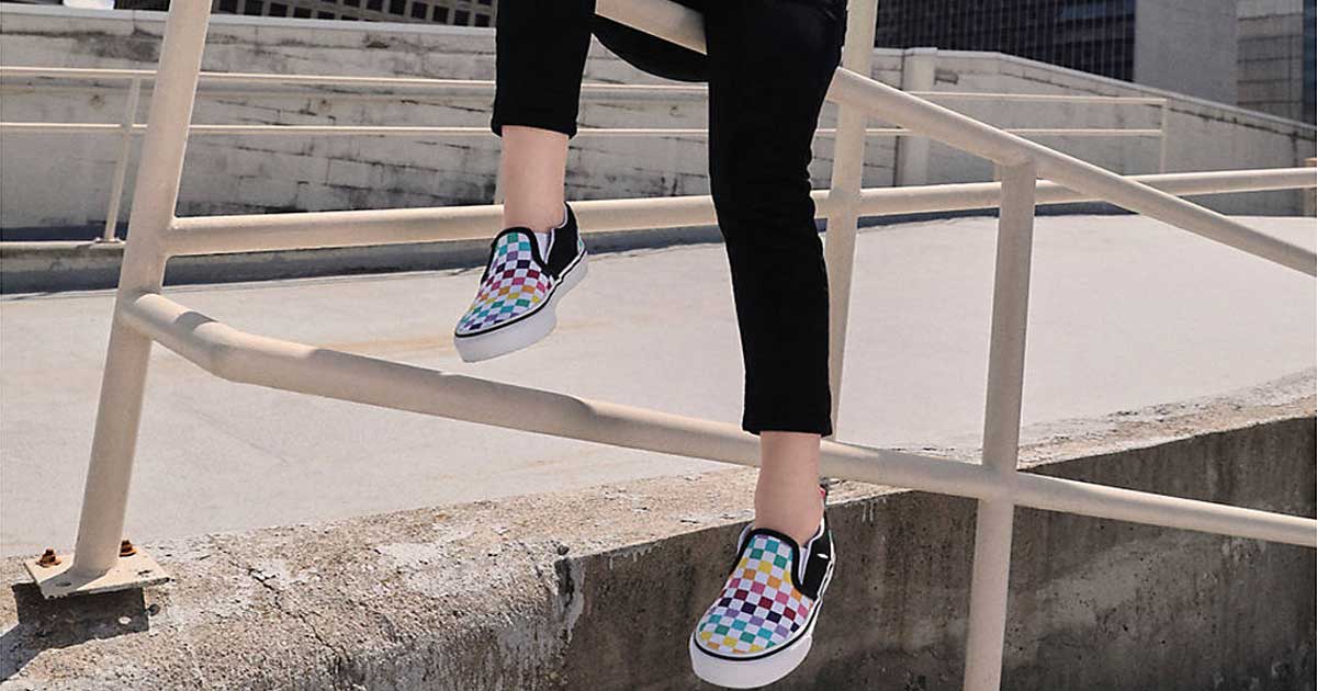 girl wearing checkered rainbow van shoes 