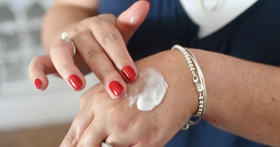 rubbing in hand cream on top of hands