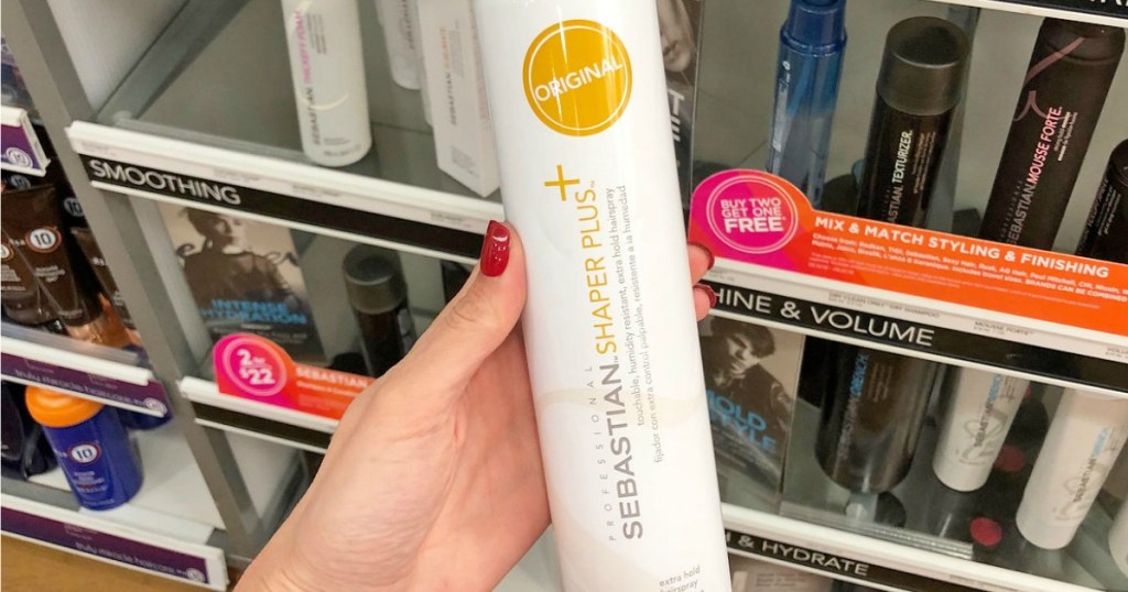 hand holding hairspray by store display