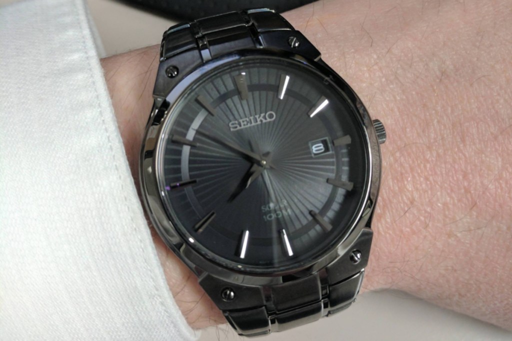 seiko black stainless steel watch on wrist