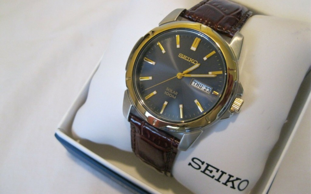 seiko brown leather strap watch on pillow