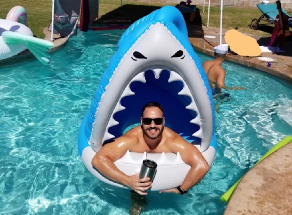 man inside shark pool float in water