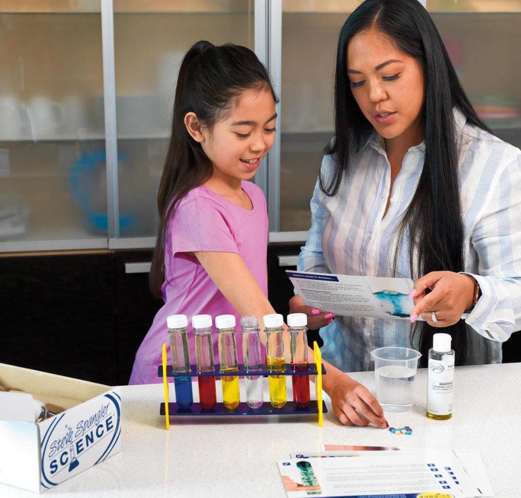 mom and daughter playing at counter with science experiment from best subscription boxes for kids